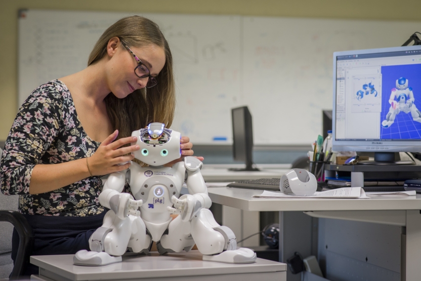 A student works on a small robot