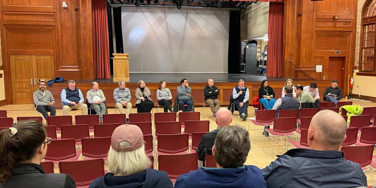 Photo of Middlebury Leadership Group sitting in chairs in an arc in front of Wilson Hall.