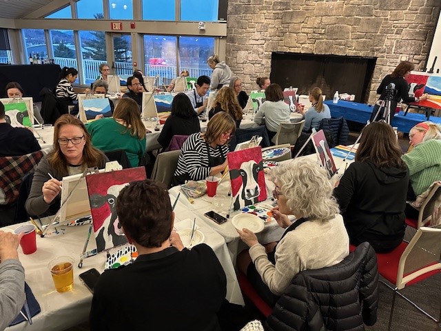 Shot of several participants in the process of painting