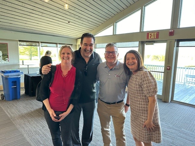 Four Colleagues Standing together smiling