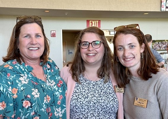 Three colleagues standing together Smiling