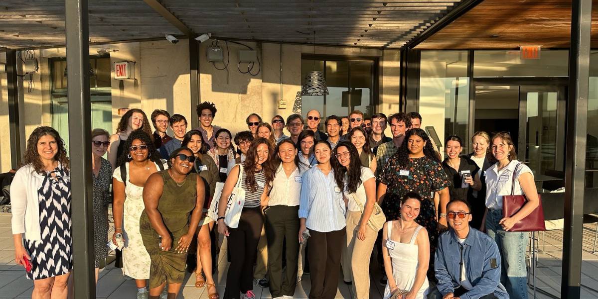 The student and alumni group, posed on the rooftop patio of Sony Music in New York, NY