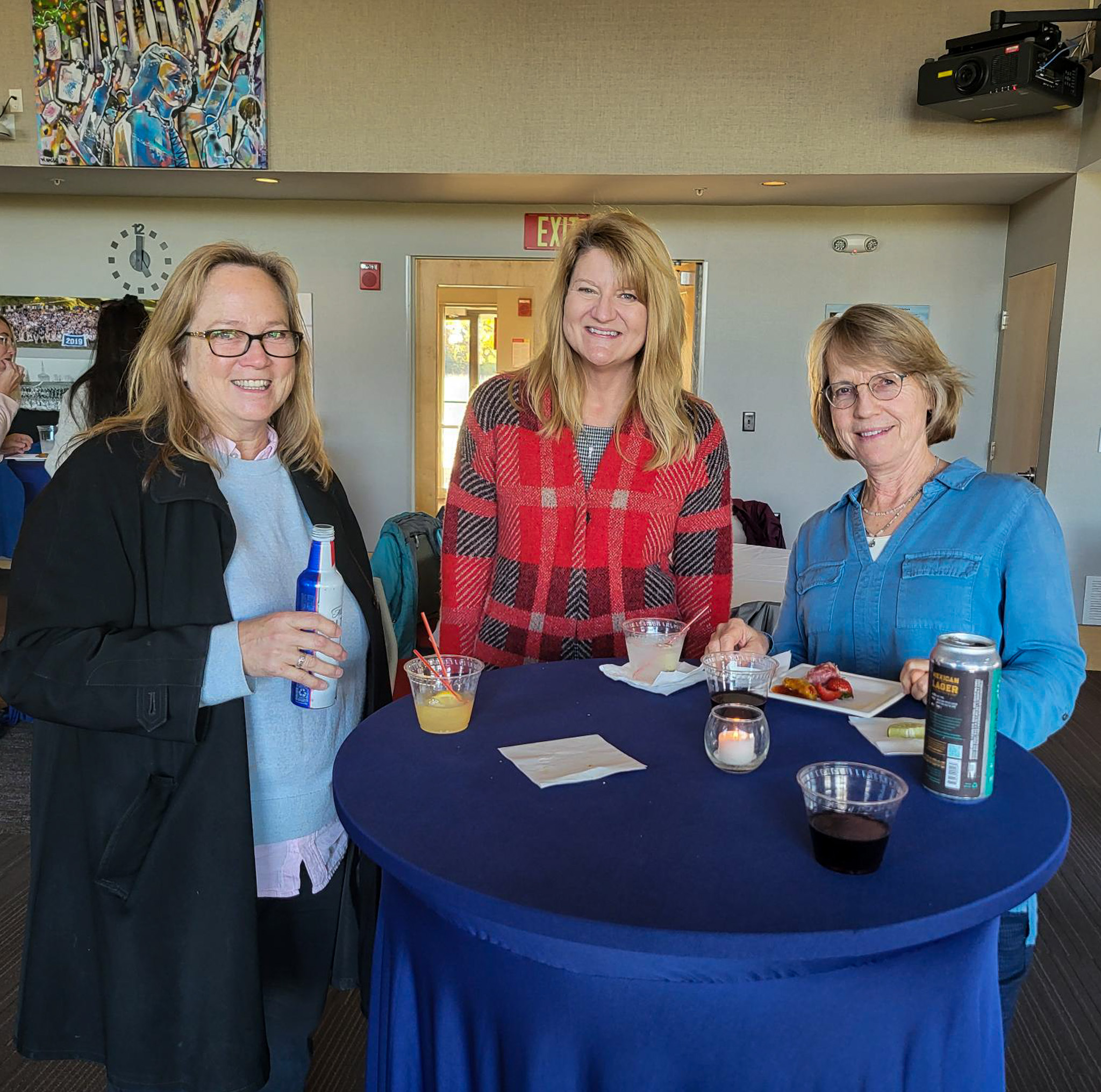 3 Colleagues standing together smiling