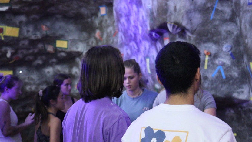 Two students looking at the climbing wall.
