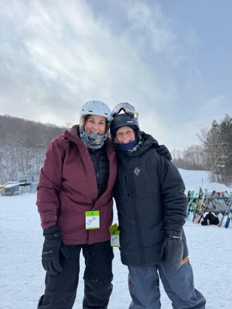 Employees standing together getting ready to get on the ski lift