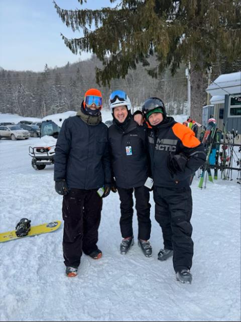 Employees standing together getting ready to go up the ski lift