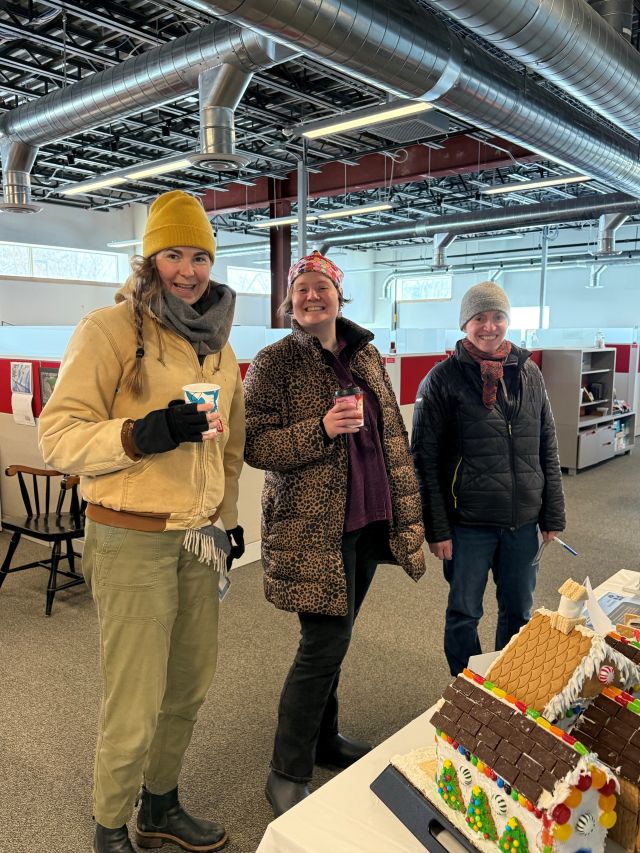 Staff members standing in HR office having hot beverages