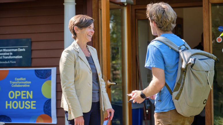 A professor and student talking outdoors.
