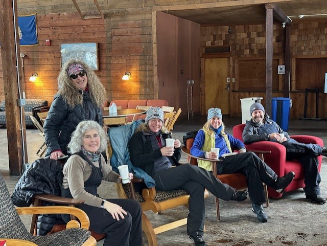 employees at rikert warming up in cabin