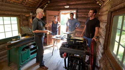 An instuctor and students using the letterpress in the Printers Cabin on the Breadloaf Campus in Ription, VT