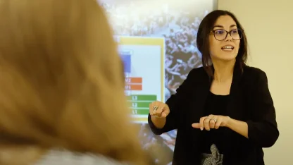 A professor teaches infront of a Language School class.