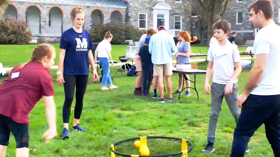 Students and their community friends play together on campus.