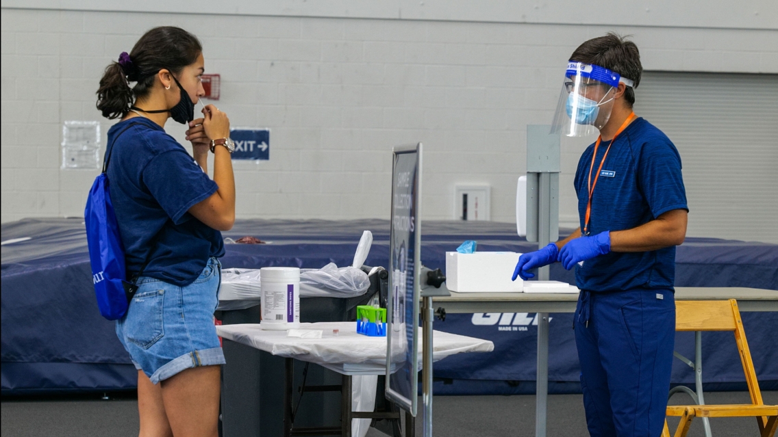 A student is tested for COVID-19 on arrival to Middlebury College.