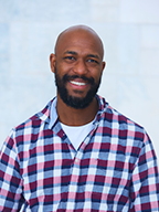 Kemi Fuentes-George, in a red-blue-and-white plaid shirt