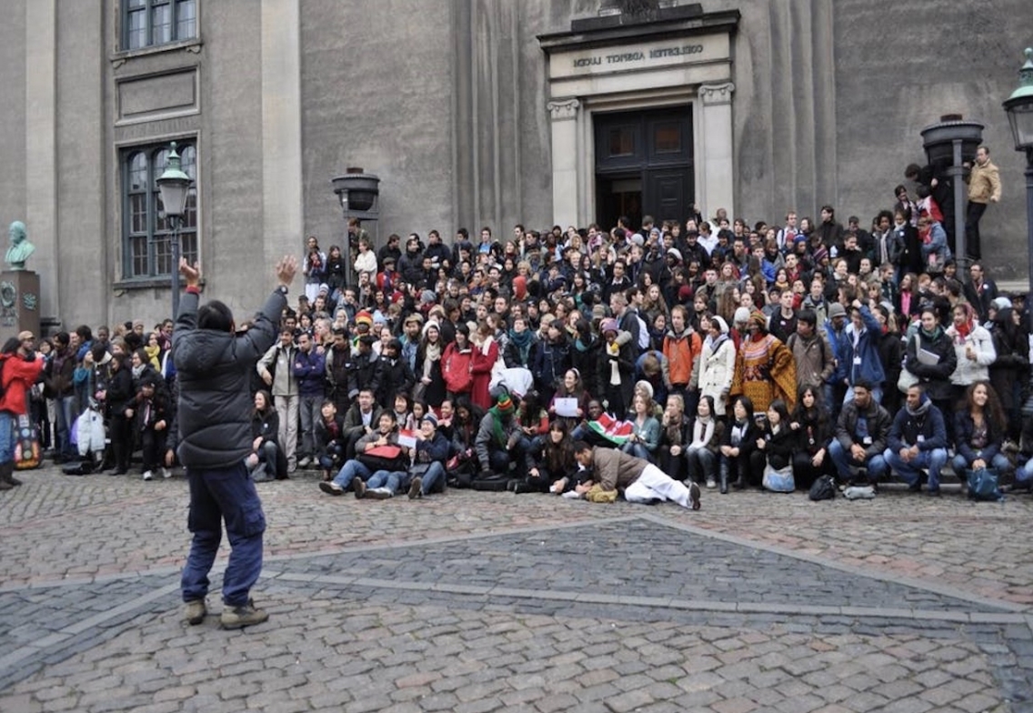 a group of students, professors, and delegates that attended COP26 post for a photo