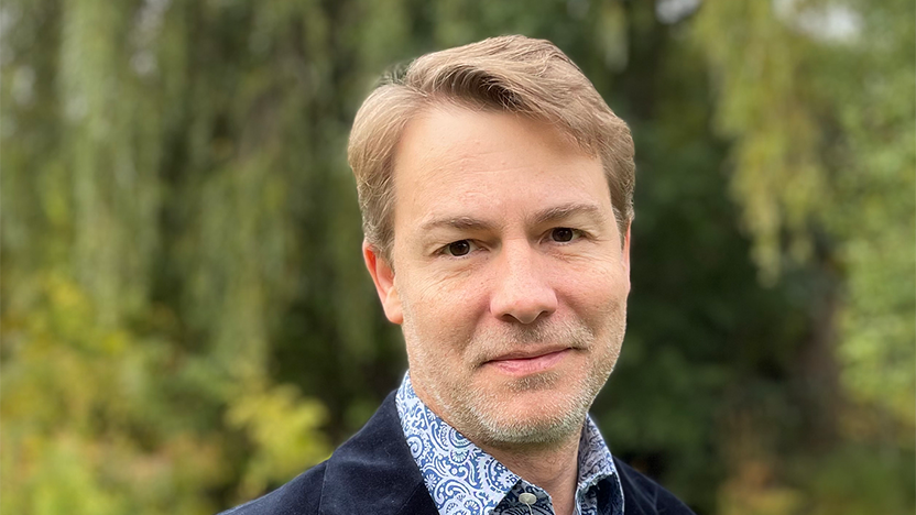 Jeff Buettner in blue-and-white checked shirt and navy jacket