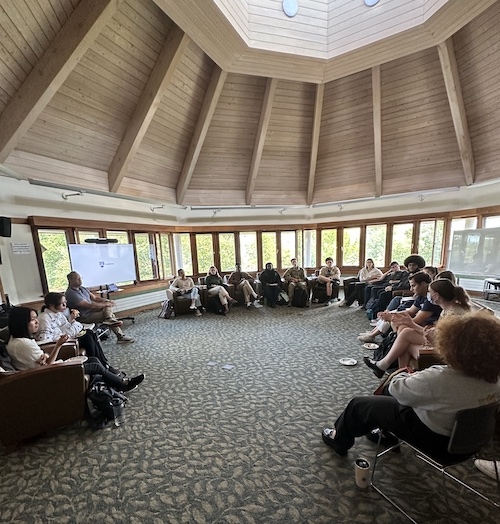 Group of students sitting at meeting.