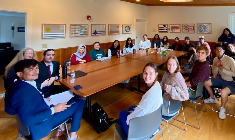 Students in Prof. Pınar's "Global Migrations" PHL course speak with legal counselors and an Afghan colleague from the Association of Africans Living in Vermont (AALV) in October 2024