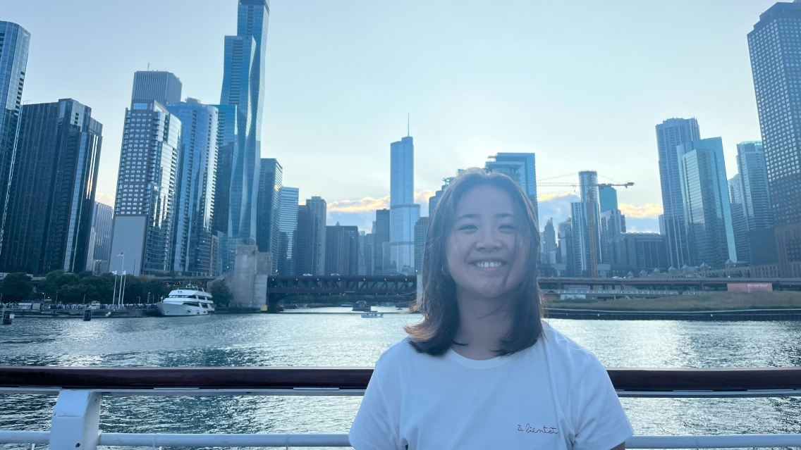 Jessica Li standing in front of a river and city scape.