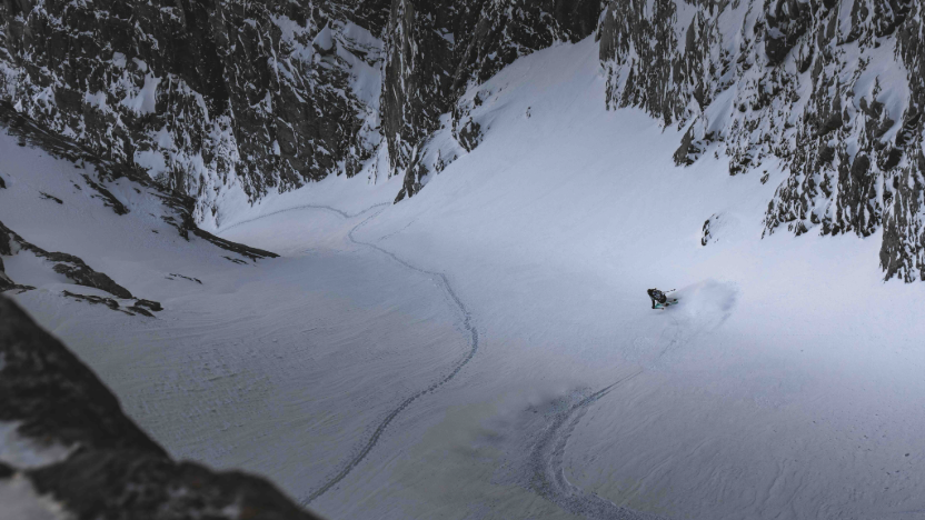 A skier is skiing down a steep slope. 