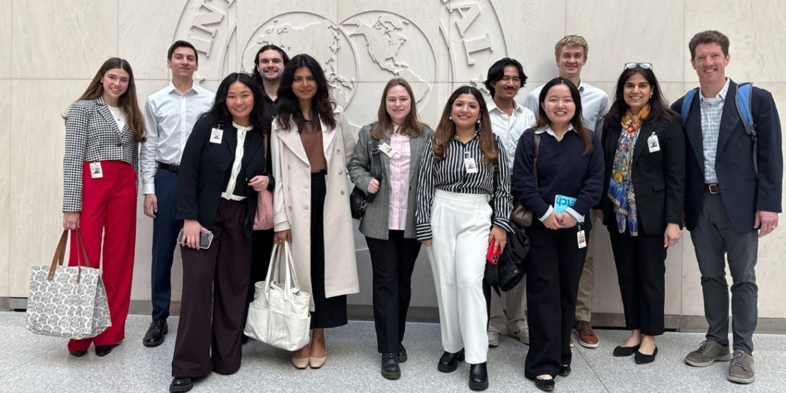 A group of students and staff dressed in business attire, during the Student Trek to Washington DC.