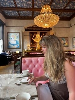 Student at a cafe with a yellow chandelier