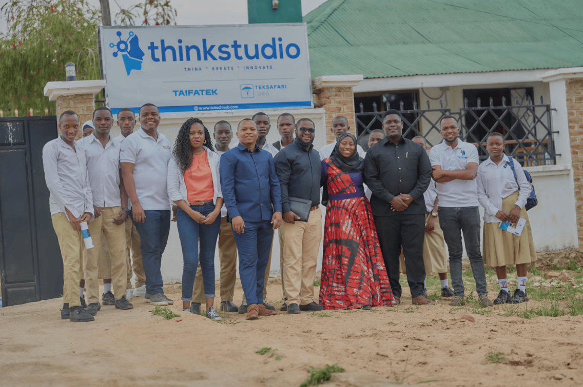 Members of thinkStudio stand together at an opening event.