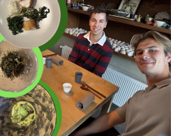 Two students at a restaurant with various plates