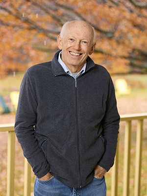 Gary Holmes in navy zip jacket with autumn Bread Loaf backdrop