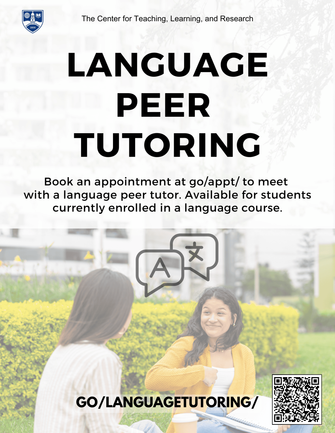 Two students sitting on the grass studying