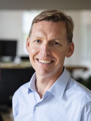 headshot of MAA Director nominee, Nick Whitman wearing a light blue dress shirt