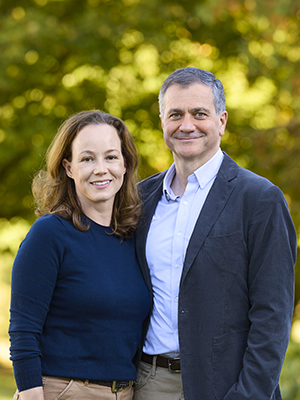 Jennifer and David Thomas outdoor portrait, both wearing Middlebury blue tops
