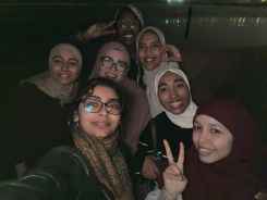 Students posing for a nighttime selfie 