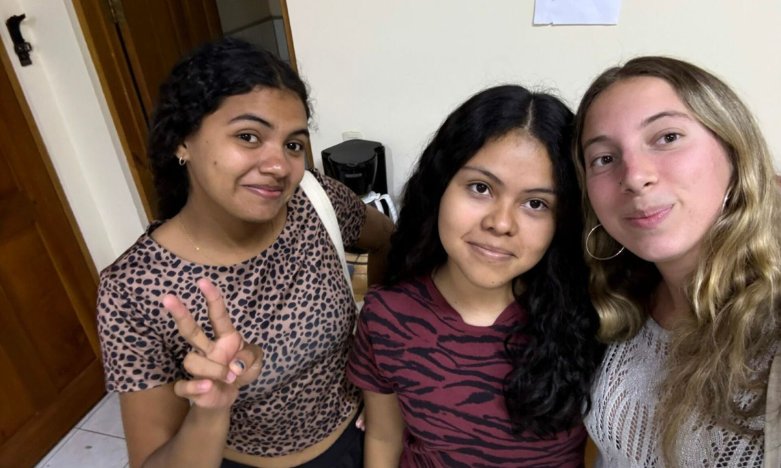 Violet Gordon takes a selfie with two of her students.