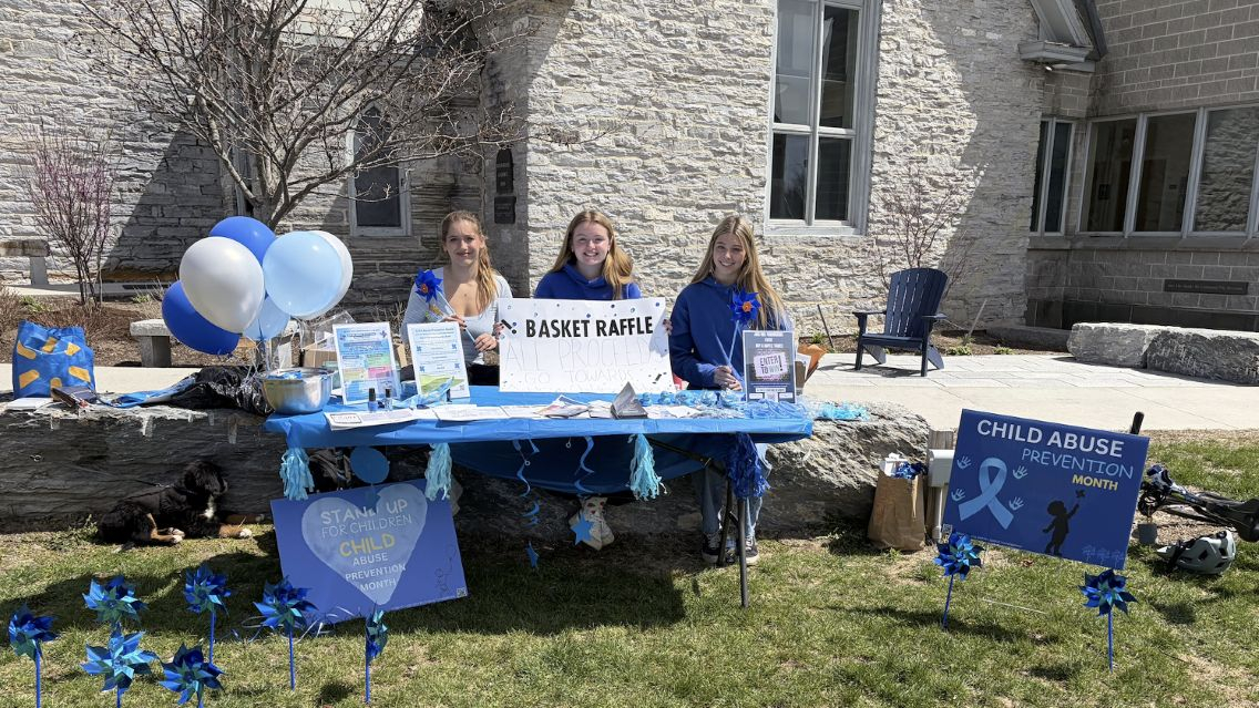 Psychology 225 students at a tabling event with Addison Children's Advocacy Center.
