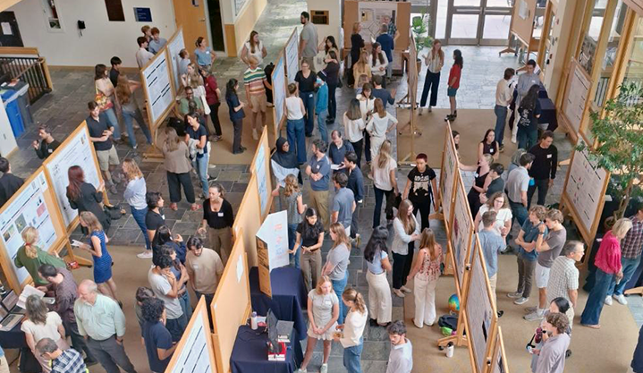 MBH Great Hall filled with posters on boards with presenters and attendees