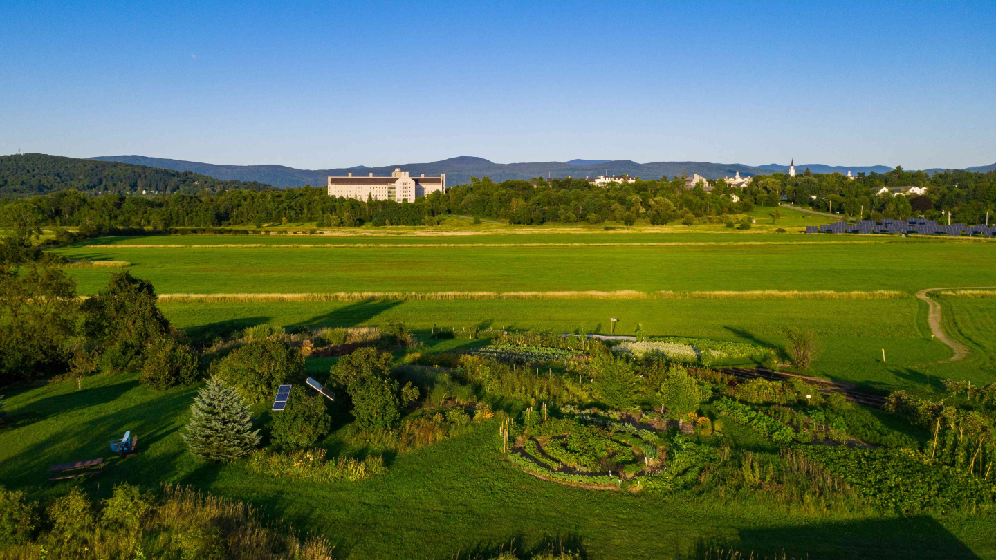 Aerial view of the Knoll with campus in the background and the green mountains behind