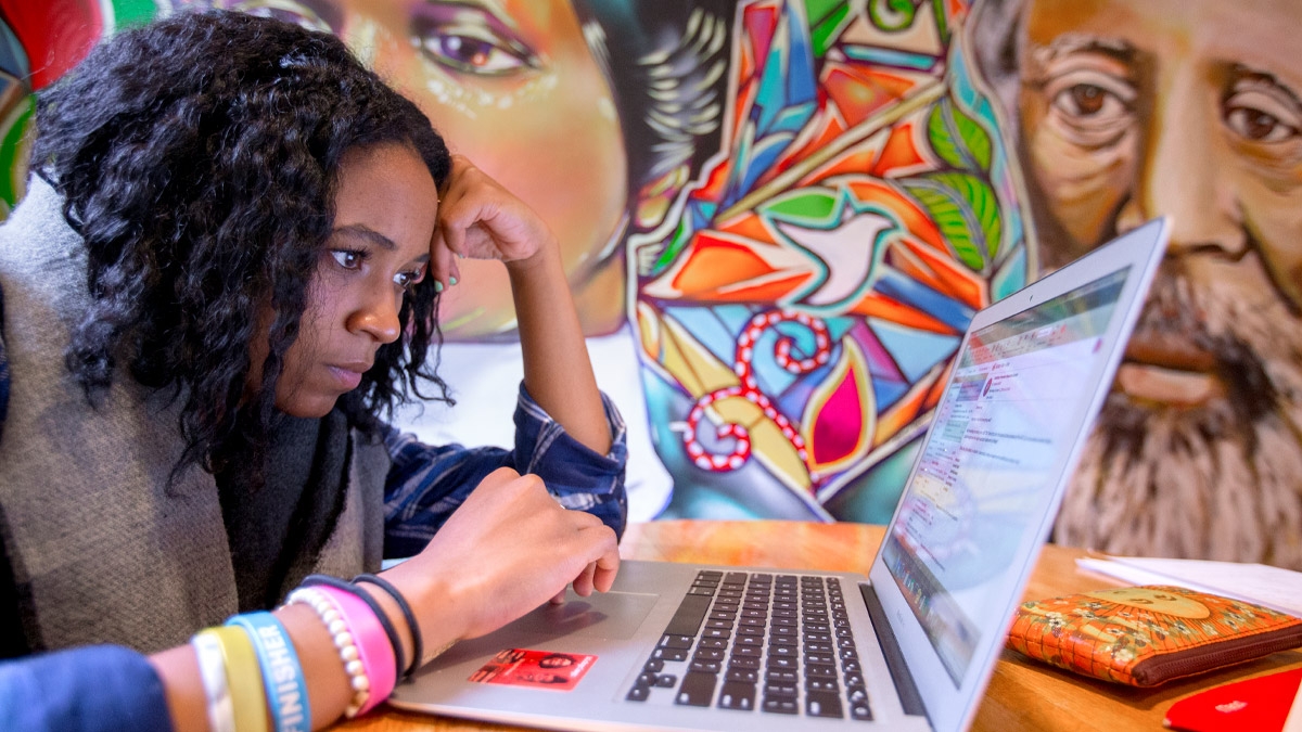 A female student works on her laptop.