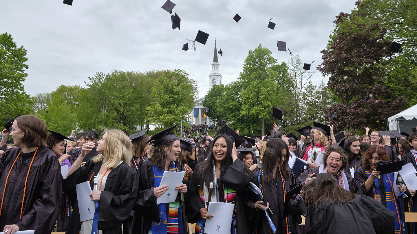 Commencent students tossing caps