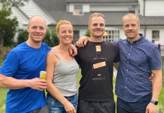 Group of four people standing next to each other for a group photo