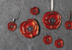 Poppy pendents lay on a piece of slate stone