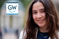 Helena Betancourt poses for a close-up picture wearing a white blazer, blue shirt, and a silver necklace.