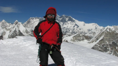 Dr Adina Racoviteanu at the summit of Mera Peak in the Nepalese Himalayas, collecting snow and ice samples.