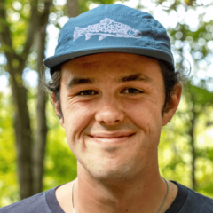 Man smiling with blue ball cap