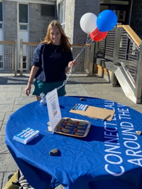 A MiddVote volunteer outside Proctor dining hall.
