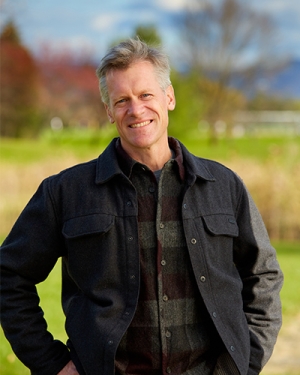 Portrait of Terry Kellogg with fall foliage in the background