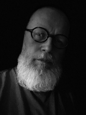 headshot of person with glasses and beard