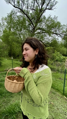 Side profile of girl in green sweater holding a basket