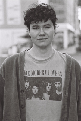 Black and white photo of man with dark hair smiling at camera