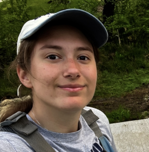student smiling wearing a hat